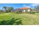 House exterior showcasing a tile roof and manicured lawn at 14173 Myakka Pointe Dr, Port Charlotte, FL 33953