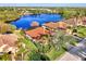 Houses near a lake, highlighting a home with a tile roof at 14394 Silver Lakes Cir, Port Charlotte, FL 33953