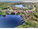 Aerial view of a lakefront home in a quiet community at 14394 Silver Lakes Cir, Port Charlotte, FL 33953