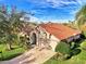 Attractive home with a tile roof and a spacious driveway, seen from above at 14394 Silver Lakes Cir, Port Charlotte, FL 33953