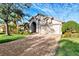 Single-story home with a tile roof, large driveway, and lush landscaping at 14394 Silver Lakes Cir, Port Charlotte, FL 33953