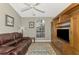 Relaxing Gathering room featuring a leather couch, built-in shelving, and a large TV at 14394 Silver Lakes Cir, Port Charlotte, FL 33953