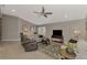 Living room with ceiling fan, comfy seating, and natural light at 14394 Silver Lakes Cir, Port Charlotte, FL 33953