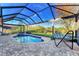 Enclosed pool and spa with a view of the lake at 14394 Silver Lakes Cir, Port Charlotte, FL 33953