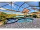 Enclosed pool and spa with a view of the lake at 14394 Silver Lakes Cir, Port Charlotte, FL 33953