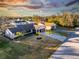 Aerial view of single Gathering home with driveway and landscaping at 1505 Fireside St, Port Charlotte, FL 33952