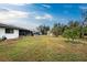 Large backyard with shed, patio, and lush landscape at 1505 Fireside St, Port Charlotte, FL 33952