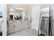 Bathroom with double vanity and a large mirror at 1505 Fireside St, Port Charlotte, FL 33952