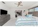 Main bedroom with TV, dresser and access to lanai at 1505 Fireside St, Port Charlotte, FL 33952