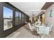 Outdoor screened porch with seating and dining table at 1505 Fireside St, Port Charlotte, FL 33952