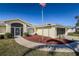 Front view of a single-story house with a walkway and American flag at 152 Sportsman Rd, Rotonda West, FL 33947