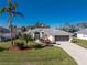 Charming single-Gathering home with a well-maintained lawn and palm trees at 152 Sportsman Rd, Rotonda West, FL 33947