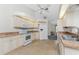 White kitchen with stainless steel appliances and granite countertops at 152 Sportsman Rd, Rotonda West, FL 33947