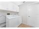 Bright laundry room with washer, dryer, and cabinets at 152 Sportsman Rd, Rotonda West, FL 33947