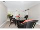 Bright dining room features a glass-top table with wicker chairs at 1600 Thomas St, Englewood, FL 34223