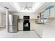 Kitchen features stainless steel appliances and white cabinetry at 1600 Thomas St, Englewood, FL 34223