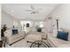 Bright living room with comfy sofas, an ottoman, and a view into the kitchen at 1600 Thomas St, Englewood, FL 34223