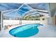 Relaxing kidney-shaped pool with screened enclosure at 1600 Thomas St, Englewood, FL 34223