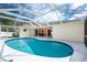 Inviting kidney-shaped pool with screened enclosure at 1600 Thomas St, Englewood, FL 34223