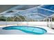 Kidney-shaped screened pool with a spacious deck at 1600 Thomas St, Englewood, FL 34223