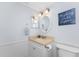 Bathroom featuring a neutral vanity and round mirror at 1701 Beach Rd # 404, Englewood, FL 34223