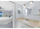 Open view of the vanity in an ensuite bathroom with access to the primary bedroom at 1701 Beach Rd # 404, Englewood, FL 34223