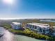 An exterior view of a low-rise residential building with a beautiful waterfront view and community pool at 1701 Beach Rd # 404, Englewood, FL 34223