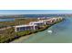 An elevated view of waterfront condominiums surrounded by lush greenery and tranquil waters at 1701 Beach Rd # 404, Englewood, FL 34223