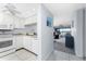 Bright, tiled kitchen leading to living room with water views at 1701 Beach Rd # 404, Englewood, FL 34223