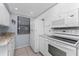 Well-lit kitchen with white cabinetry, modern appliances, and neutral countertops at 1701 Beach Rd # 404, Englewood, FL 34223