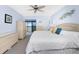 Serene main bedroom with neutral tones, balcony access, and water views at 1701 Beach Rd # 404, Englewood, FL 34223