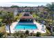 Community pool with lounge chairs and shaded seating area at 1783 Lake Pl # 1783A, Venice, FL 34293