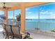 Screened balcony overlooking the water with comfortable seating at 1901 Illinois Ave, Englewood, FL 34224