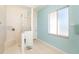 Large walk-in shower with neutral tile and light blue walls at 1901 Illinois Ave, Englewood, FL 34224