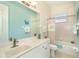 Charming bathroom with light teal walls and beige tile at 1901 Illinois Ave, Englewood, FL 34224