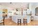 Modern white kitchen with island, quartz countertops and stainless steel appliances at 1901 Illinois Ave, Englewood, FL 34224