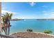 Stunning water view from balcony, featuring palm trees and waterfront landscape at 1901 Illinois Ave, Englewood, FL 34224