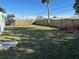 Large backyard with a wooden fence and palm tree at 21179 Glendale Ave, Port Charlotte, FL 33952