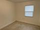 Small bedroom with window and terrazzo flooring at 21179 Glendale Ave, Port Charlotte, FL 33952