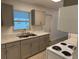 Galley kitchen with gray cabinets and marble countertops at 21179 Glendale Ave, Port Charlotte, FL 33952