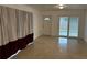 Living room featuring terrazzo floors and burgundy curtains at 21179 Glendale Ave, Port Charlotte, FL 33952