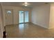 Living room with sliding glass doors and terrazzo flooring at 21179 Glendale Ave, Port Charlotte, FL 33952