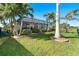 Landscaped backyard with tropical plants, a pool and screened enclosure at 214 W Pine Valley Ln, Rotonda West, FL 33947