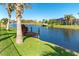 Private dock on a serene canal with lush tropical landscaping at 214 W Pine Valley Ln, Rotonda West, FL 33947