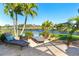 Spacious patio with lounge chairs, offering a tranquil view at 214 W Pine Valley Ln, Rotonda West, FL 33947