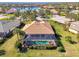 Aerial view of a house with a pool and spa, screened enclosure, and spacious yard at 2619 Myakka Marsh Ln, Port Charlotte, FL 33953