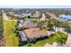 Aerial view of luxury homes with pools, lush landscaping, and a lake at 2619 Myakka Marsh Ln, Port Charlotte, FL 33953