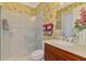 Bathroom with a walk-in shower, toilet, and floral wallpaper at 2619 Myakka Marsh Ln, Port Charlotte, FL 33953