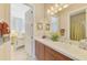 Guest bathroom with double vanity and a view to a bedroom at 2619 Myakka Marsh Ln, Port Charlotte, FL 33953