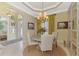 Bright dining room with round table, chandelier, and view of entryway at 2619 Myakka Marsh Ln, Port Charlotte, FL 33953